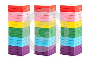 Stacked colorful wooden blocks toys on white background. Creative, diverse, expanding, rising or growing