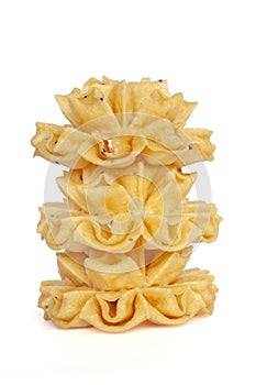 Stacked of Crispy Lotus Blossom Cookie is Thai dessert Khanom Dok Jok isolated on white background.