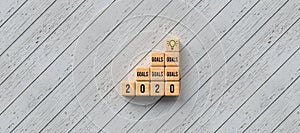 Stacked cubes with message GOALS 2020 and a lightbulb symbol - 3D rendered illustration