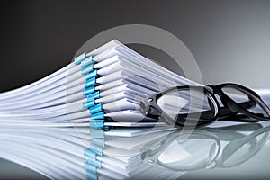 Stacked Documents With Blue Paperclips