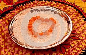 Stacked in heart shape sugar candy bites on a steel plate.