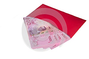 Stacked of hundred Thai banknote in red envelope