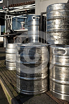 Stacked large metal beer barrels