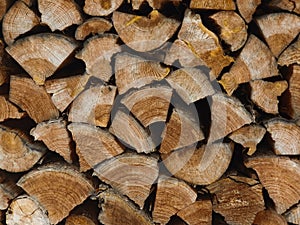 Stacked logs of firewood, irregular cross-sections