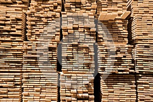 Stacked lumber. Folded wood. Boards in the warehouse