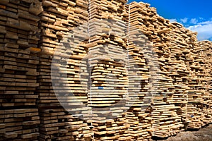 Stacked lumber. Folded wood. Boards in the warehouse