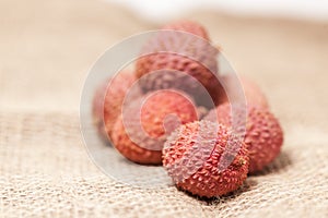 Stacked lychee fruits on sack-linen cloth