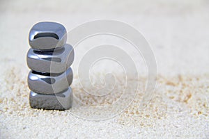 Stacked Metallic Stones on Sand