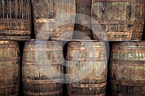 Stacked old whisky barrels