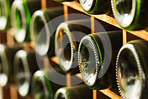 Stacked of old wine bottles in the cellar