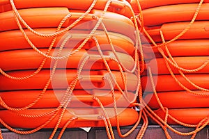 Stacked orange rescue round buoy, sea marine lifesaver