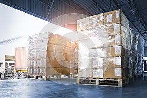 Stacked of Package Boxes Loading into Container Truck. Truck Parked Loading at Dock Warehouse. Delivery Service.