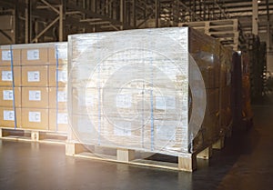 Stacked of Package Boxes Wrapped Plastic Flim on Pallets at Storage Warehouse. Shipping Warehouse Logistics
