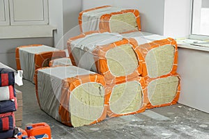 Stacked packages of thermal insulation material in room