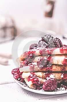 Stacked pancakes with fresh berries