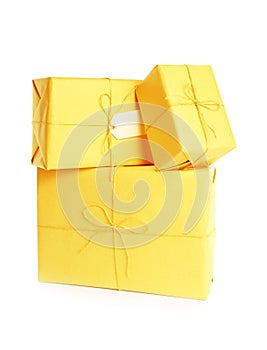 Stacked parcels wrapped in kraft paper on white