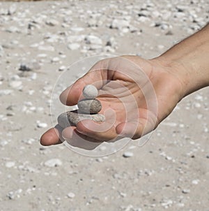 Stacked pebble stones in man`s hand