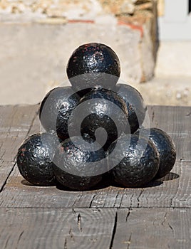 Stacked pile of old cannonballs