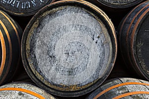 Stacked pile of old wooden barrels and casks at whisky distiller