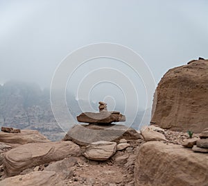 Stacked pile of stones and rocks on tranquil desert background