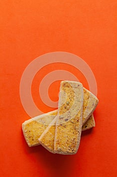 Stacked Pistachio bakery cookies, on orange background.