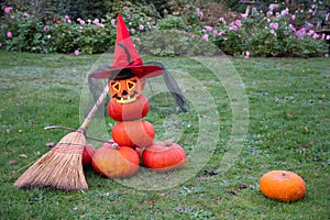 stacked pumpkin pyramid stuffed with halloween spooky ghost in hat and mask