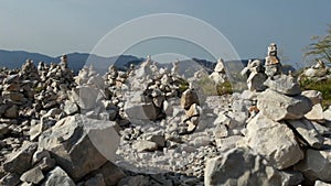 Stacked rock towers on mountain top - camera pan