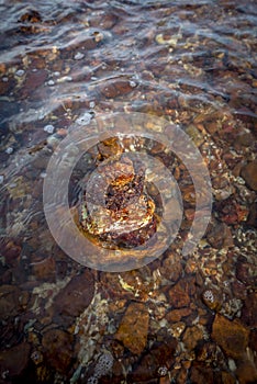 Stacked of rock in the waving sea