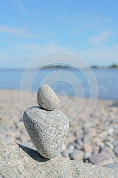 Stacked Rocks balancing, stacking with precision. Stone tower on the shore. Copy space