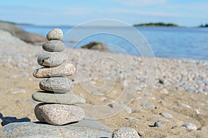 Stacked Rocks balancing, stacking with precision. Stone tower on the shore. Copy space