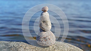 Stacked Rocks balancing, stacking with precision. Stone tower on the shore. Copy space