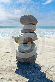 Stacked Rocks balancing, stacking with precision. Stone tower on the shore. Copy space