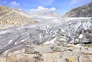 Stacked rocks with blue sky and Rhone glacier