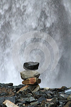 Stacked Rocks in Front of Waterfall