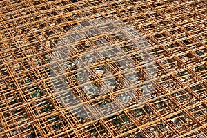 Stacked rusty steel wire mesh for slab concrete work at the construction site