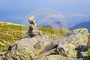 Stacked small rocks on top of the mountain summit of Madrid, La Morcuera.