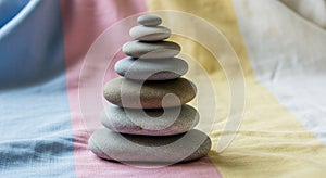 Stacked smooth stones are arranged vertically