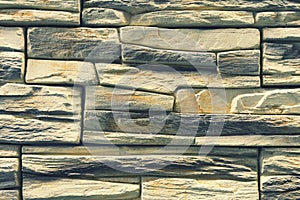 Stacked stone wall, natural stone cladding. Stone wall for background,Slab stone wall texture. Wall background of volcanic