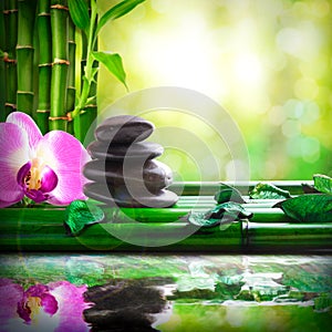 Stacked stones on bamboo reflected in water massage and relax