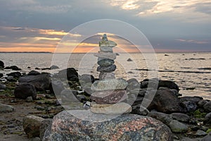 Stacked stones on a coast at sunset