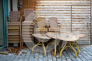 Stacked tables and chairs on the terrace of a restaurant, closed during lockdown due to coronavirus pandemic