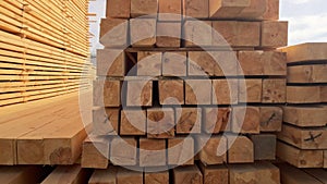 Stacked Timber Planks at a Lumberyard Awaiting Transportation. Stacked wooden planks in varying shades of brown at a