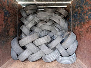 Stacked tires. Pile of old wheels piled up in container. Recycling and environment. Workshops and vehicle spare parts