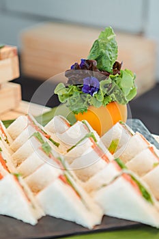 A stacked triangular salmon sandwich