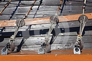 Stacked and well-folded ropes on the deck of a sailing ship. Accessories needed for sailing