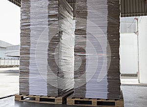 Stacked white corrugated cardboard boxes on pallet rack. supply store warehousing storage.