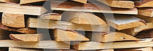 Stacked wood logs with varied grain patterns and natural texture