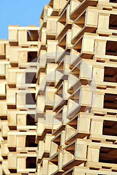 Stacked wooden pallet under blue sky