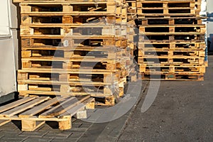 Stacked wooden pallets at a storage or near a shop