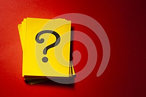 Stacked yellow cards with printed question mark